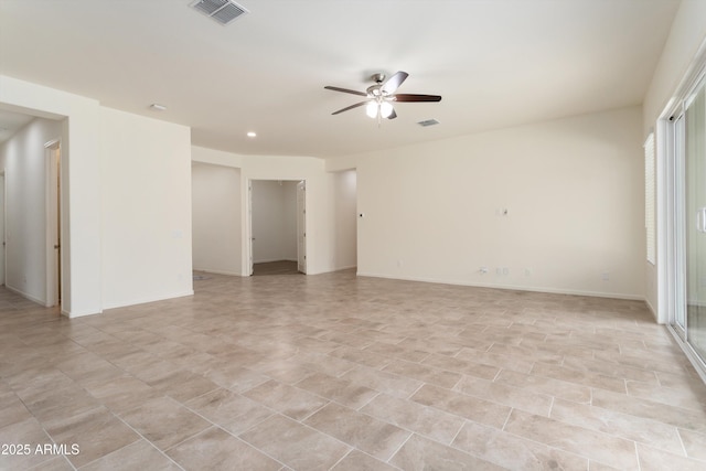 spare room featuring baseboards, visible vents, and ceiling fan