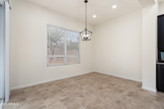 unfurnished dining area with recessed lighting and baseboards