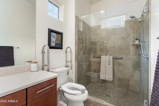 full bath with toilet, vanity, and a shower stall