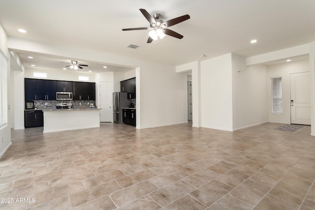 unfurnished living room featuring baseboards, recessed lighting, visible vents, and ceiling fan