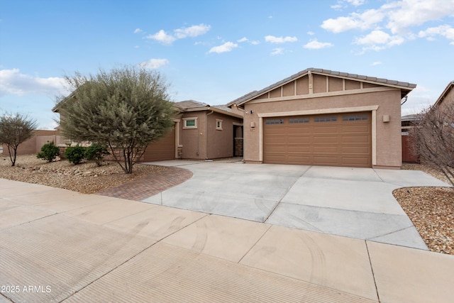 ranch-style house featuring stucco siding, concrete driveway, and a garage