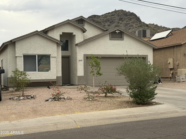 10006 N 7th Pl, Phoenix, AZ 85020 - view of front of home featuring stucco siding, an attached garage, concrete driveway, a mountain view, and central air condition unit