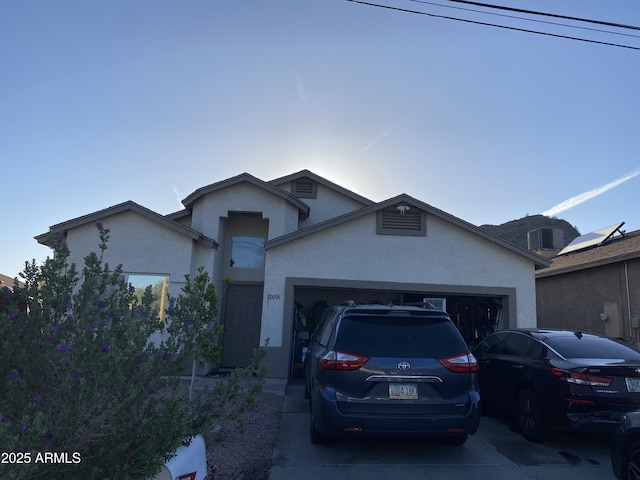 10006 N 7th Pl, Phoenix, AZ 85020 - ranch-style home with stucco siding, an attached garage, and concrete driveway