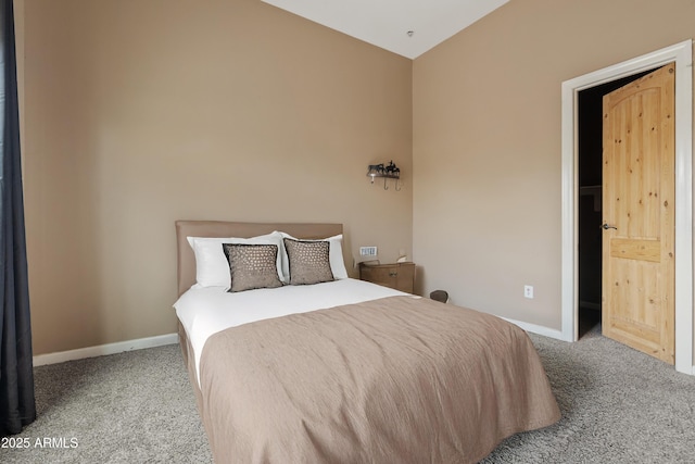 bedroom featuring carpet and lofted ceiling