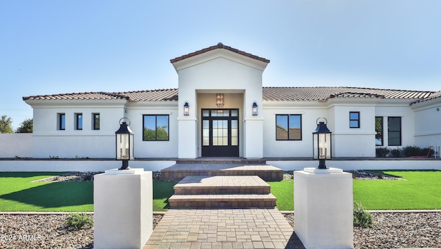 mediterranean / spanish-style home featuring a front yard