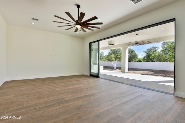 unfurnished room with ceiling fan and hardwood / wood-style flooring