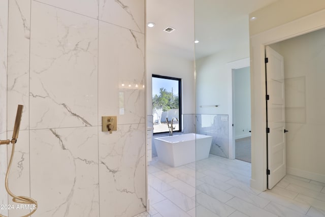 bathroom with tile walls and a washtub