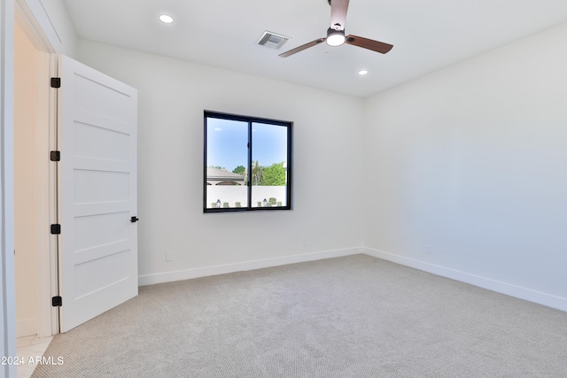 empty room featuring light carpet and ceiling fan