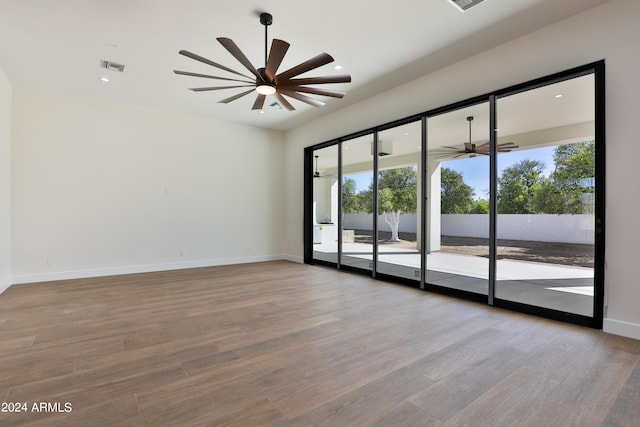 spare room featuring light hardwood / wood-style floors and ceiling fan