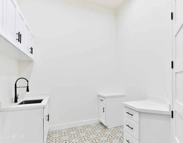 clothes washing area with sink