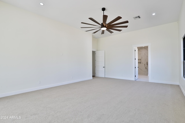 carpeted spare room featuring ceiling fan