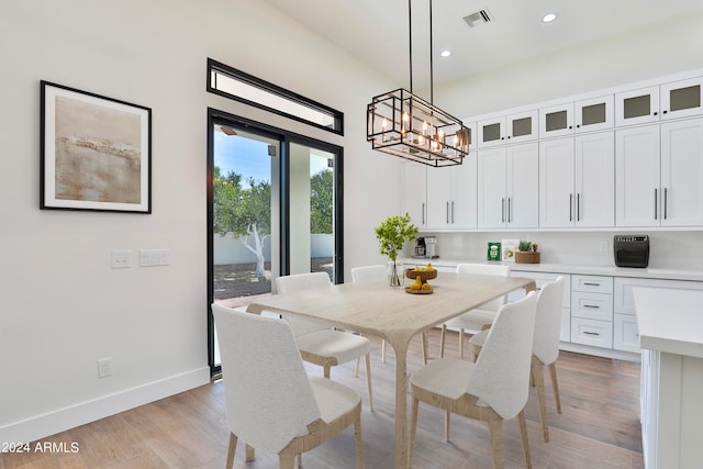 dining area featuring an inviting chandelier and light wood-type flooring