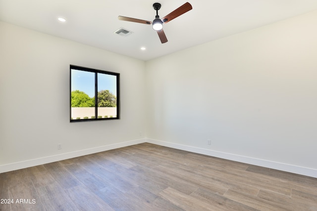 empty room with light wood-type flooring and ceiling fan