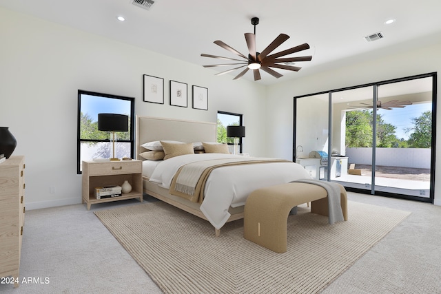 bedroom featuring ceiling fan, light colored carpet, and access to exterior