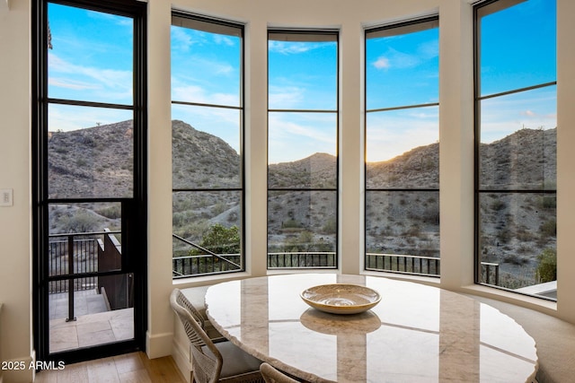 sunroom / solarium featuring a mountain view and a wealth of natural light