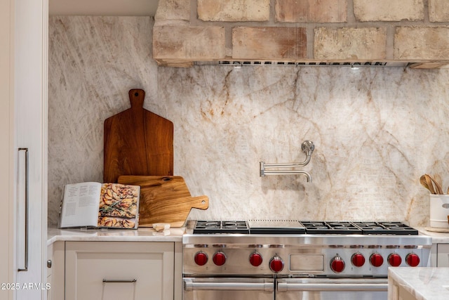 kitchen with white cabinetry and stainless steel stove