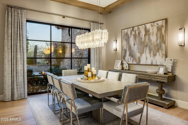 dining area featuring light hardwood / wood-style floors and a notable chandelier