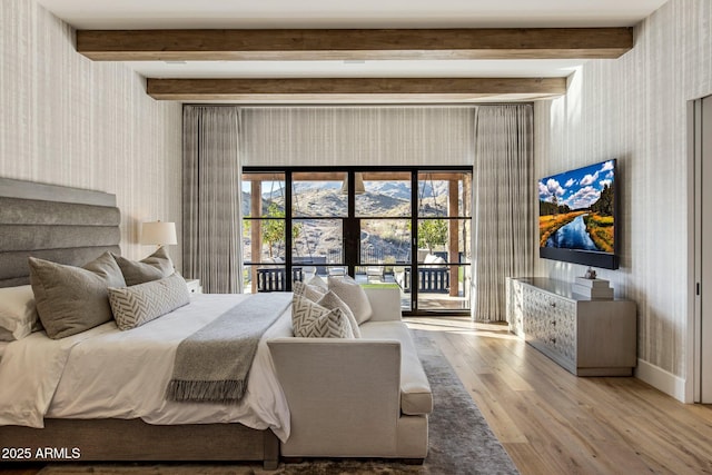 bedroom with beamed ceiling, access to exterior, and light hardwood / wood-style floors