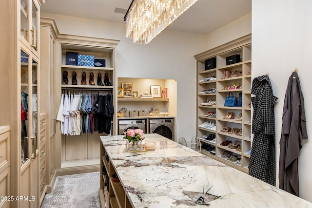 walk in closet featuring washing machine and clothes dryer