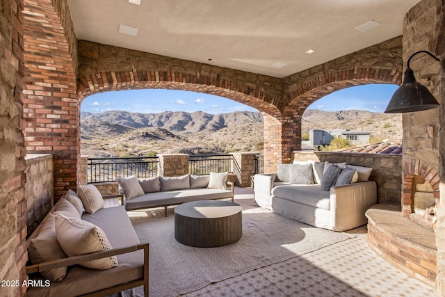 view of patio / terrace with a mountain view and an outdoor hangout area