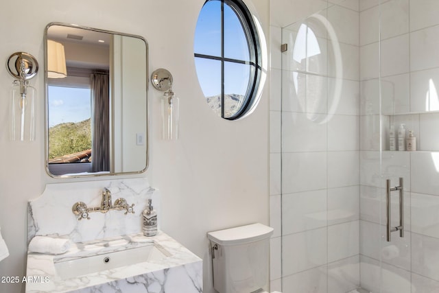 bathroom with a shower with door, sink, decorative backsplash, and toilet