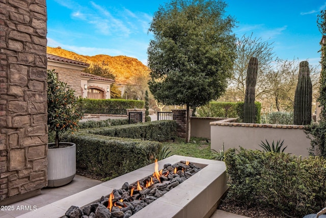 view of yard with a mountain view and an outdoor fire pit