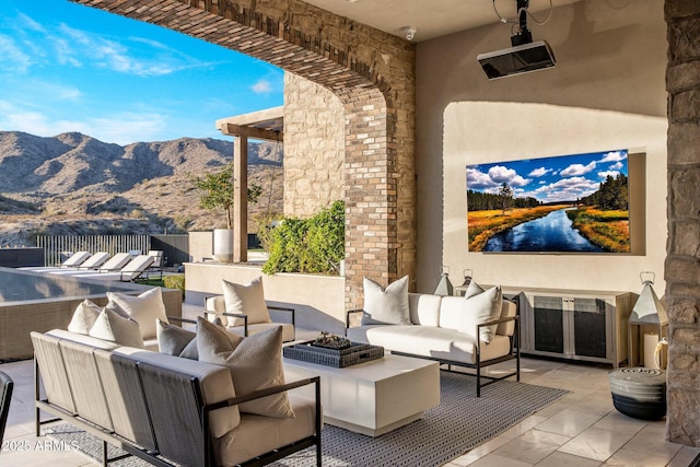 view of patio / terrace featuring an outdoor living space with a fire pit