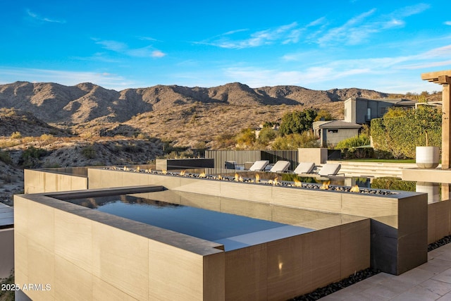 view of swimming pool featuring a mountain view