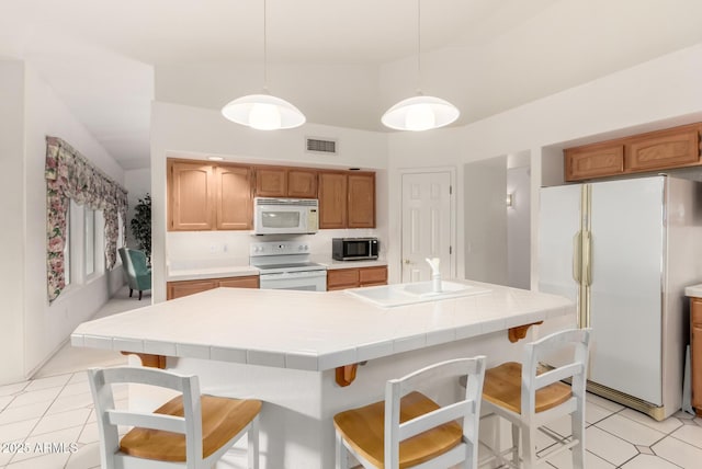 462 N Bedford Ct, Chandler, AZ 85225 - kitchen with white appliances, a sink, a breakfast bar area, pendant lighting, and a center island