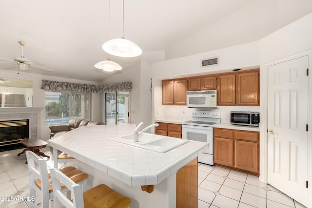 462 N Bedford Ct, Chandler, AZ 85225 - kitchen with white appliances, a sink, open floor plan, tile countertops, and a ceiling fan