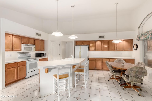 462 N Bedford Ct, Chandler, AZ 85225 - kitchen with white appliances, high vaulted ceiling, a sink, a center island with sink, and a kitchen breakfast bar