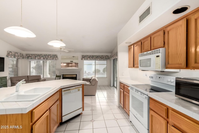 462 N Bedford Ct, Chandler, AZ 85225 - kitchen with white appliances, open floor plan, tile countertops, a sink, and a fireplace