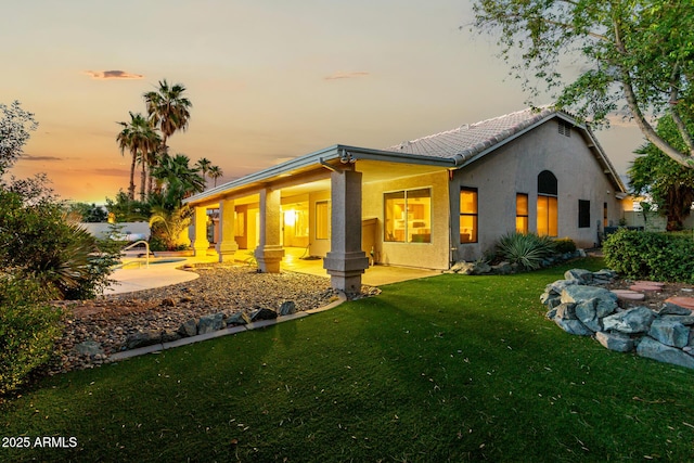 462 N Bedford Ct, Chandler, AZ 85225 - back of house with stucco siding, a yard, a tile roof, and a porch