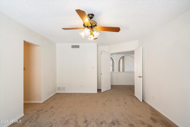 unfurnished bedroom featuring carpet floors, baseboards, visible vents, and a textured ceiling