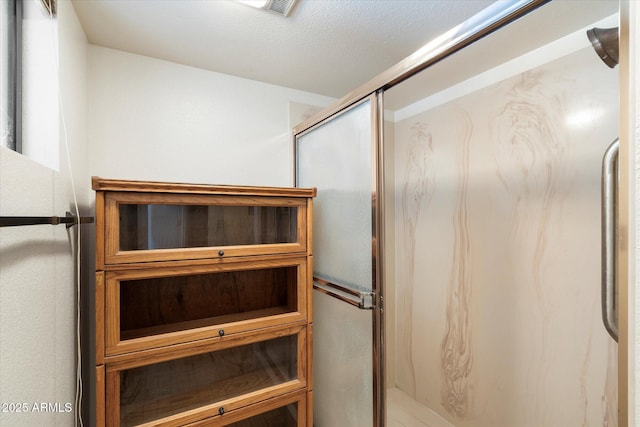 full bathroom with visible vents and a marble finish shower