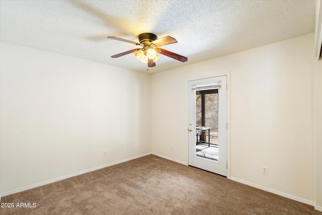 carpeted spare room with ceiling fan, a textured ceiling, and baseboards