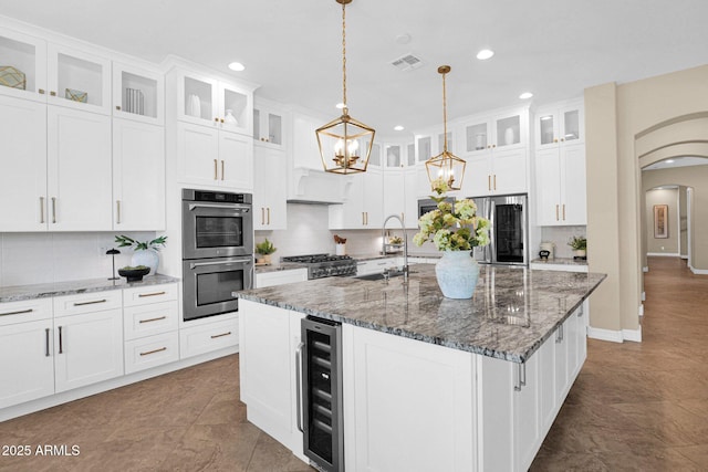20151 E Via Del Palo St, Queen Creek, AZ 85142 - kitchen with beverage cooler, appliances with stainless steel finishes, recessed lighting, arched walkways, and a chandelier