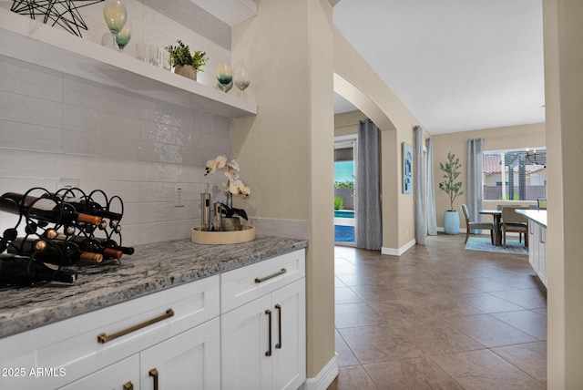 20151 E Via Del Palo St, Queen Creek, AZ 85142 - bar featuring backsplash, arched walkways, and light tile patterned floors