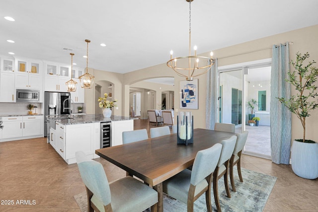 20151 E Via Del Palo St, Queen Creek, AZ 85142 - dining space with arched walkways, a chandelier, recessed lighting, light tile patterned floors, and wine cooler