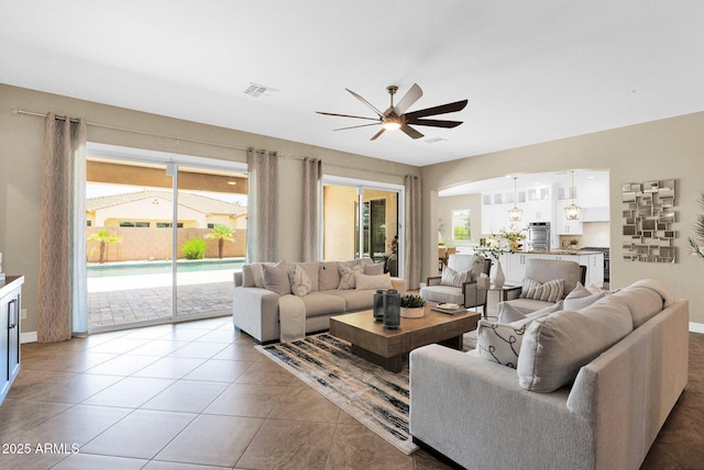 20151 E Via Del Palo St, Queen Creek, AZ 85142 - living area featuring a ceiling fan, plenty of natural light, and light tile patterned floors