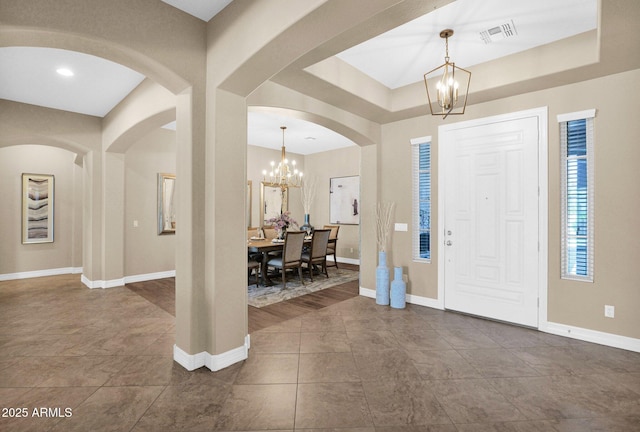 20151 E Via Del Palo St, Queen Creek, AZ 85142 - foyer entrance with a chandelier, arched walkways, and dark tile patterned floors