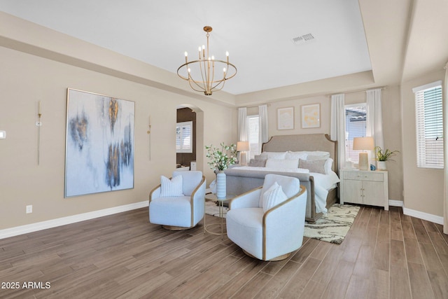 20151 E Via Del Palo St, Queen Creek, AZ 85142 - bedroom with arched walkways, wood finished floors, multiple windows, and a chandelier