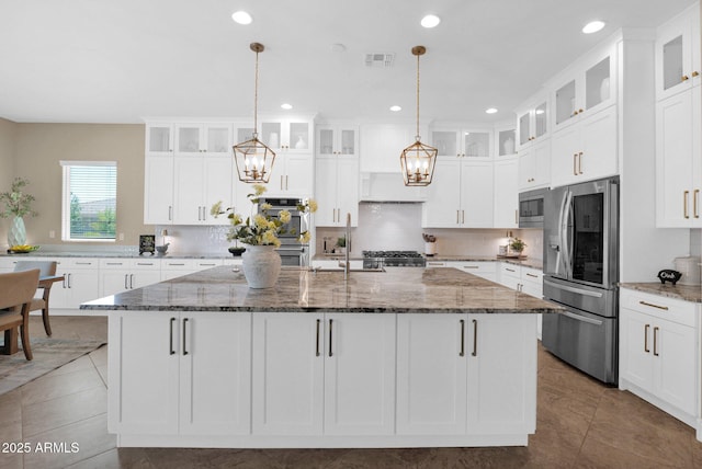 20151 E Via Del Palo St, Queen Creek, AZ 85142 - kitchen featuring stainless steel appliances, a chandelier, an island with sink, backsplash, and custom exhaust hood
