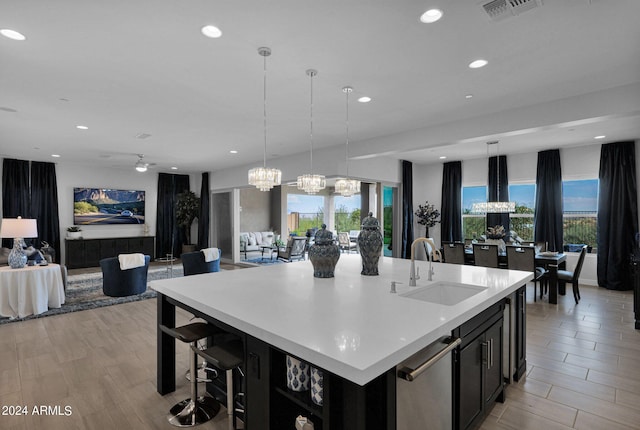 kitchen with a notable chandelier, sink, hanging light fixtures, and a large island