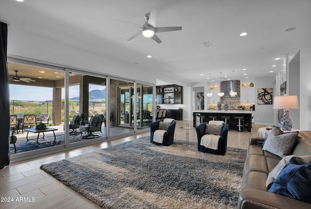 living room with ceiling fan and a mountain view