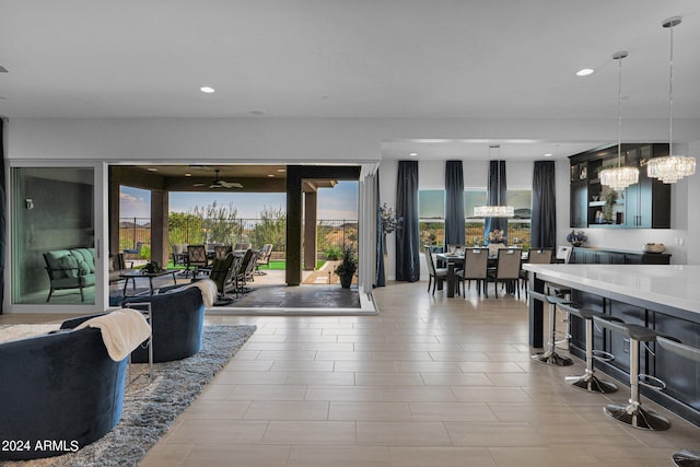 living room featuring ceiling fan with notable chandelier