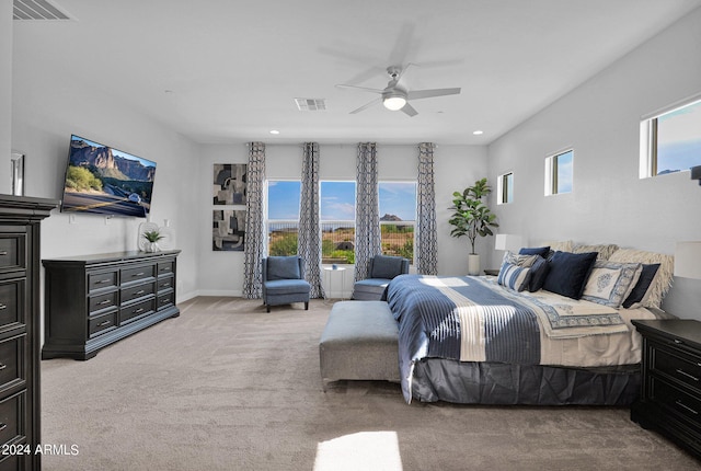 bedroom featuring ceiling fan, carpet floors, and multiple windows