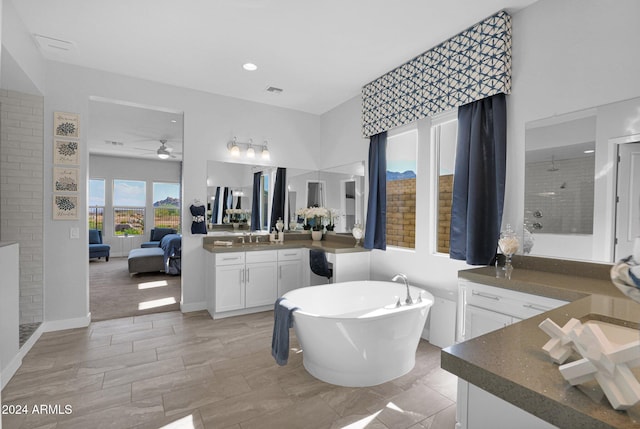 bathroom with ceiling fan, vanity, and shower with separate bathtub