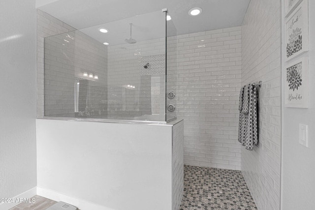 bathroom with a tile shower