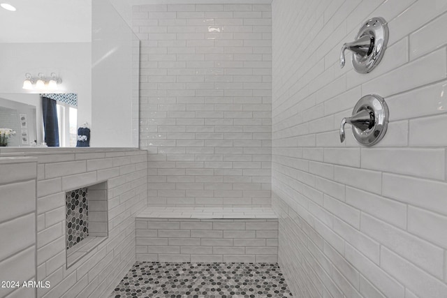 bathroom with tiled shower